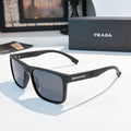 Rectangular sunglasses with black frame and dark gray-blue lenses
