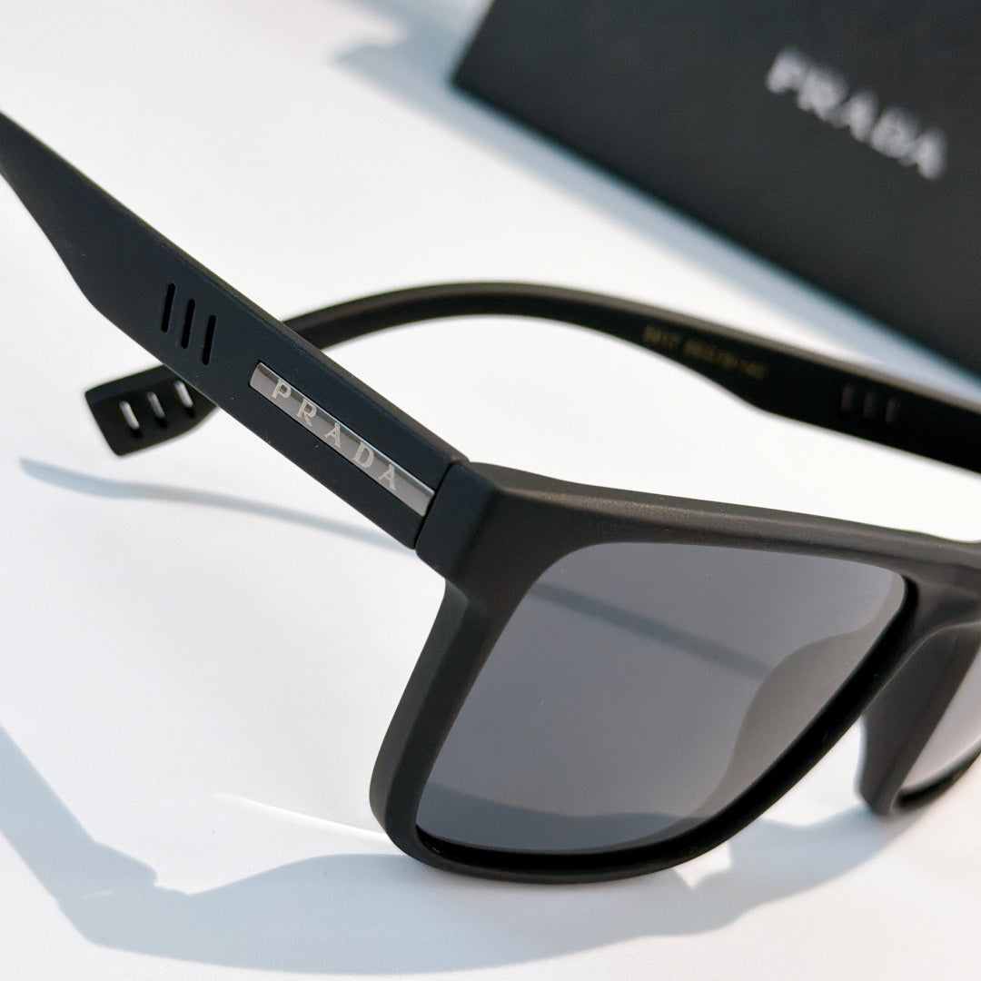 Rectangular sunglasses with matte black frame and dark tinted lenses, side angle