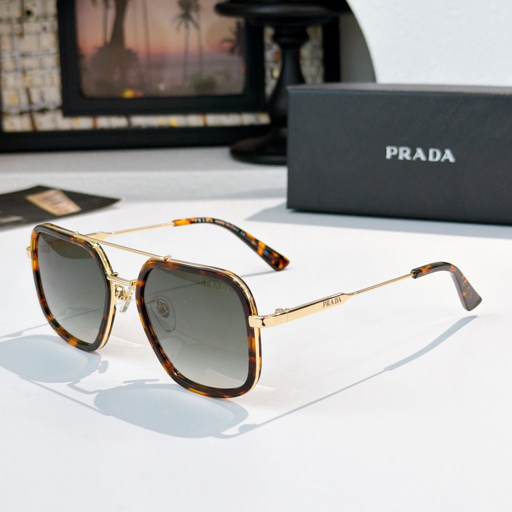 Prada sunglasses with dark lenses, tortoiseshell temples, and gold-tone metal frame