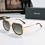 Prada sunglasses with dark lenses, tortoiseshell temples, and gold-tone metal frame