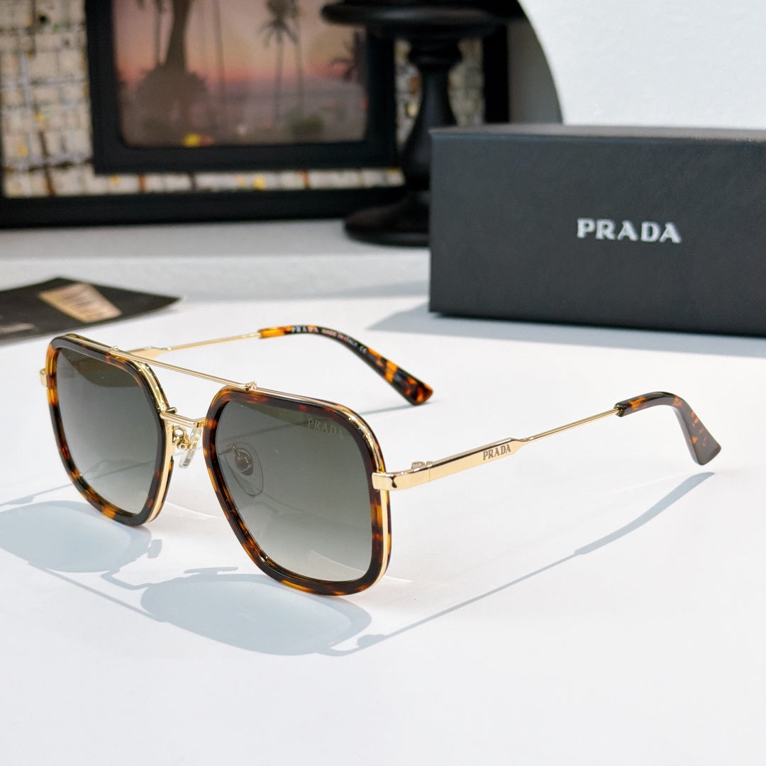 Prada sunglasses with dark lenses, tortoiseshell temples, and gold-tone metal frame