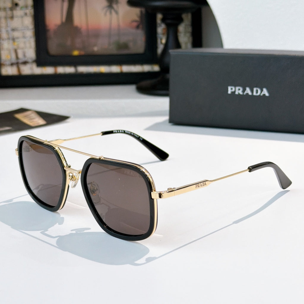 Prada sunglasses with dark lenses, black frames, and gold-tone metal arms