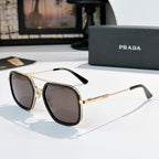 Prada sunglasses with dark lenses, black frames, and gold-tone metal arms