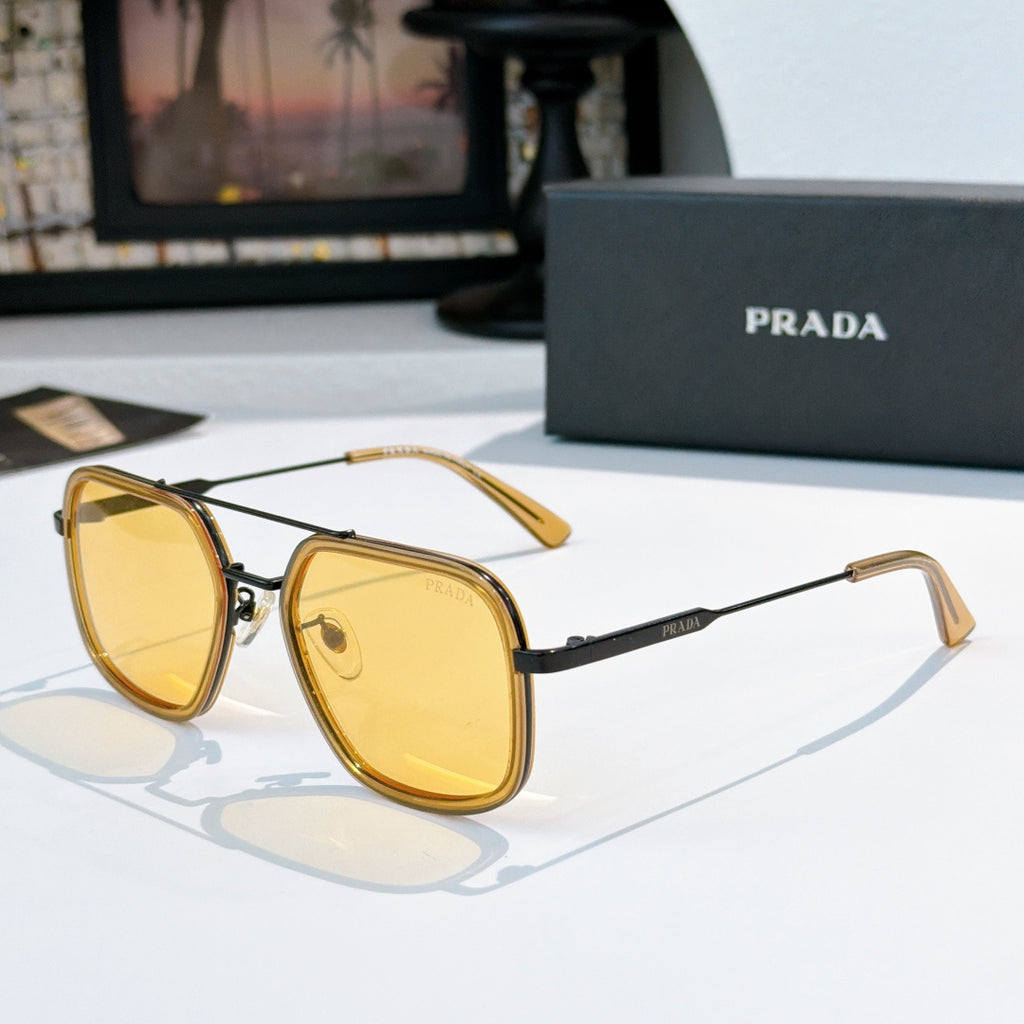 Prada sunglasses with yellow lenses, gold-tone frames, and matching temple arms