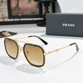 Prada sunglasses with amber-tinted lenses, gold-tone frames, and dark arms
