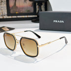 Prada sunglasses with amber-tinted lenses, gold-tone frames, and dark arms