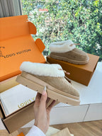 Louis Vuitton shearling loafers, tan suede upper with white fur collar and stitched edge