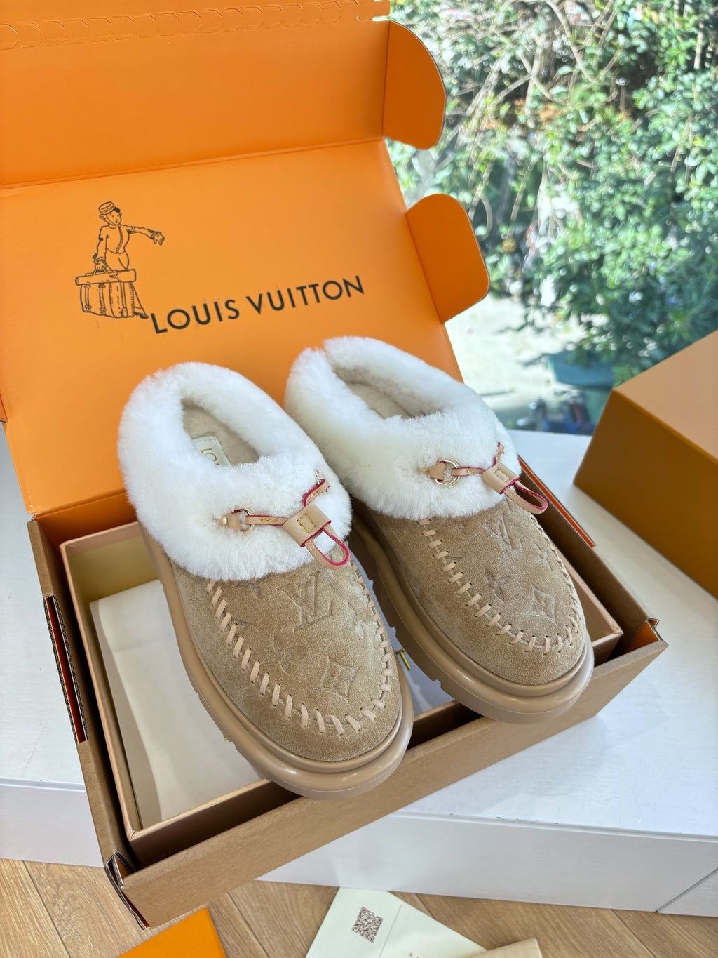 Louis Vuitton shearling loafers, tan suede with white fur lining and red trim