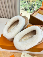 Louis Vuitton tan shearling loafers, close-up of white fur lining and logo front strap