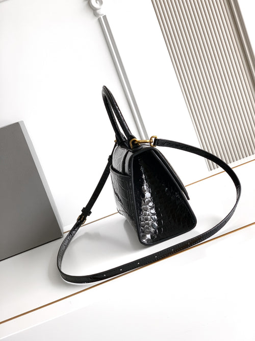 Black croc-embossed handbag with short top handle and long shoulder strap