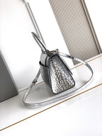Silver croc-embossed mini bag with top handle, adjustable shoulder strap, and clasp
