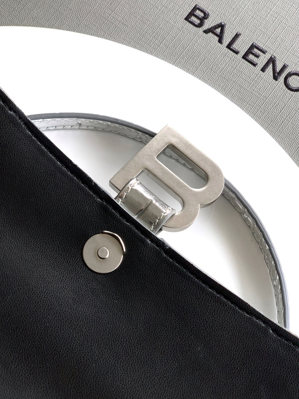 Gray lining with Balenciaga lettering and silver buckle on strap