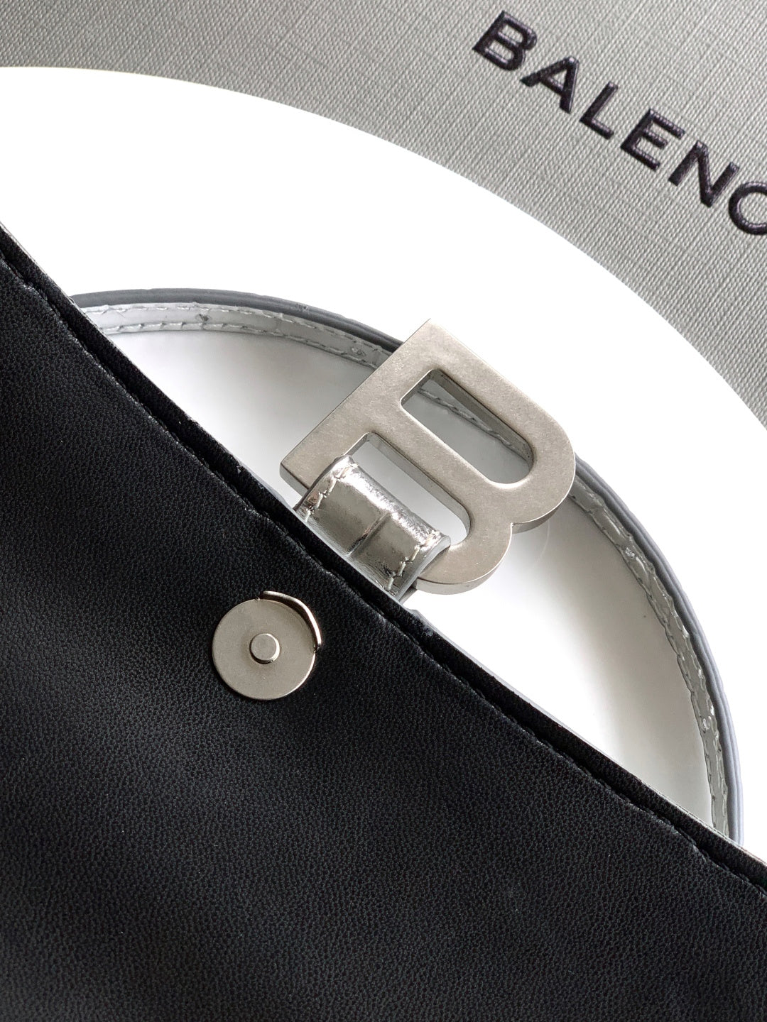 Gray lining with Balenciaga lettering and silver buckle on strap