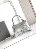 Silver croc-embossed top-handle bag with adjustable shoulder strap and front clasp