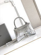 Silver croc-embossed top-handle bag with adjustable shoulder strap and front clasp