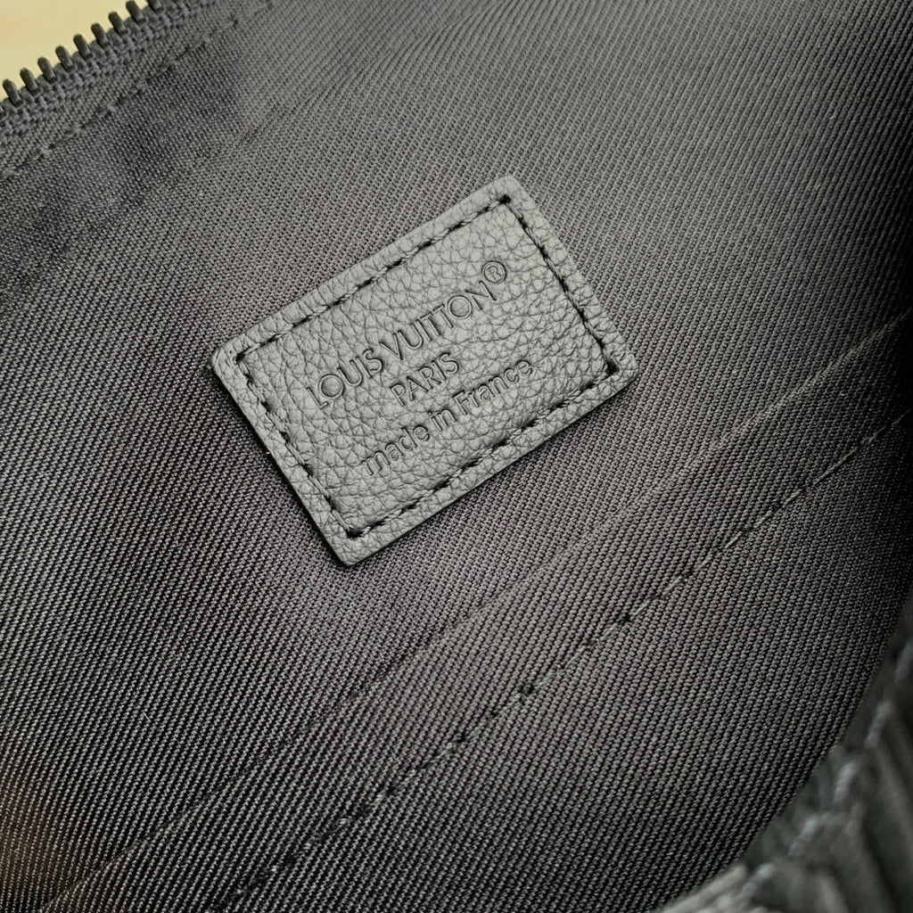 Louis Vuitton leather bag interior label with logo text and stitched border