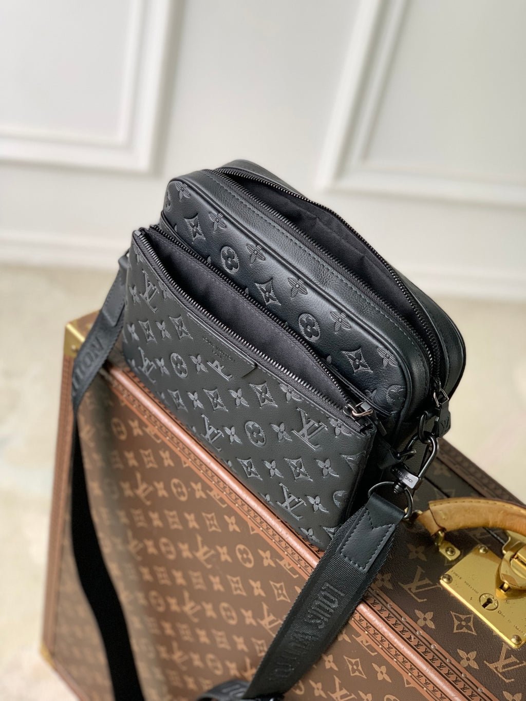 Louis Vuitton monogram crossbody bag with gold-tone clasp and adjustable strap