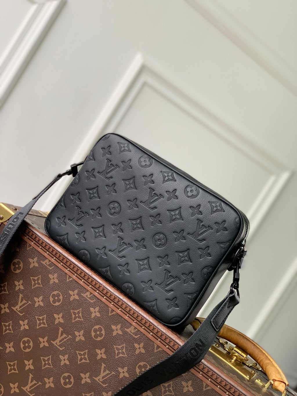 Louis Vuitton monogram crossbody bag with front zipper and black shoulder strap