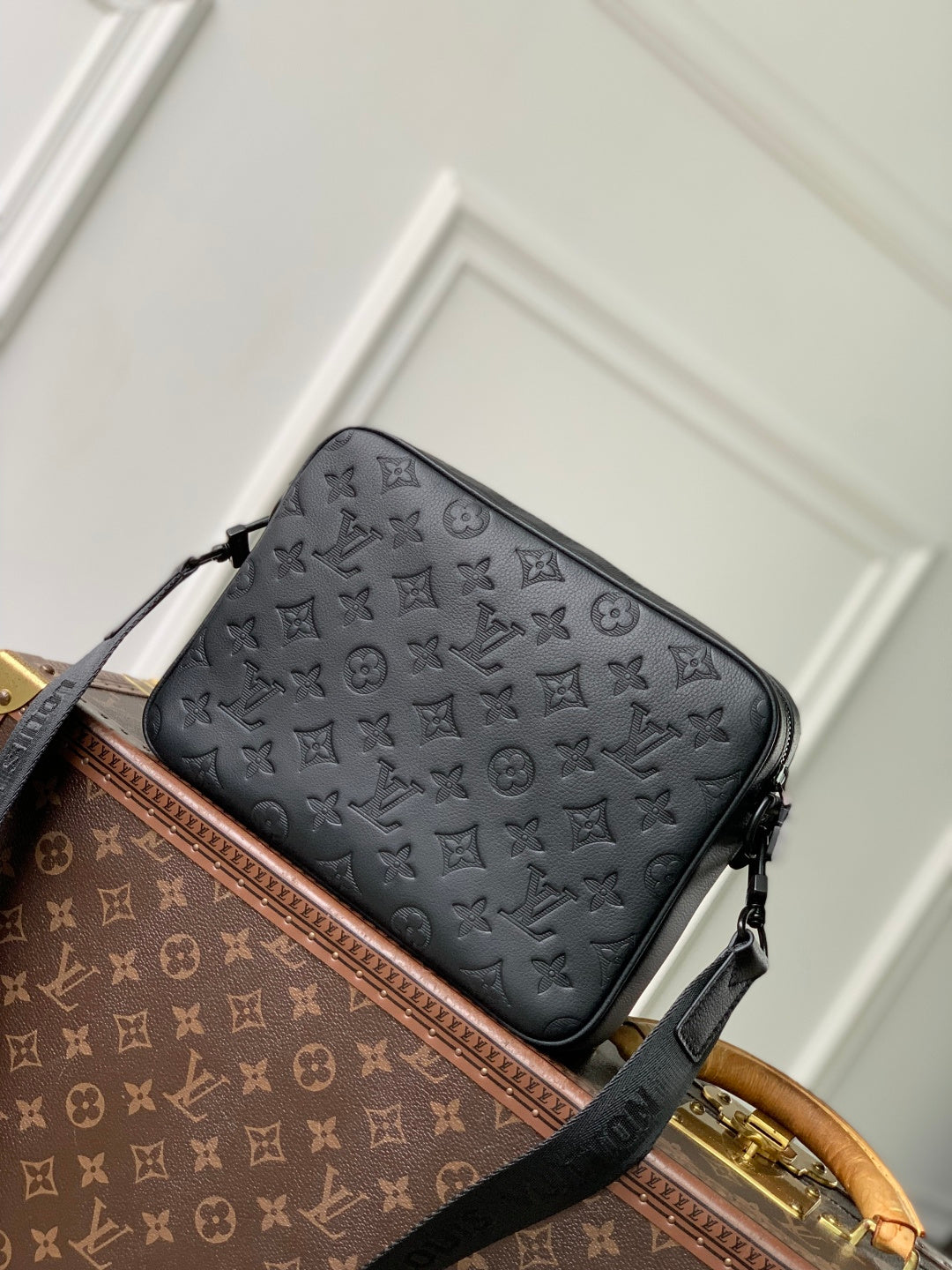 Louis Vuitton monogram crossbody bag with front zipper and black shoulder strap