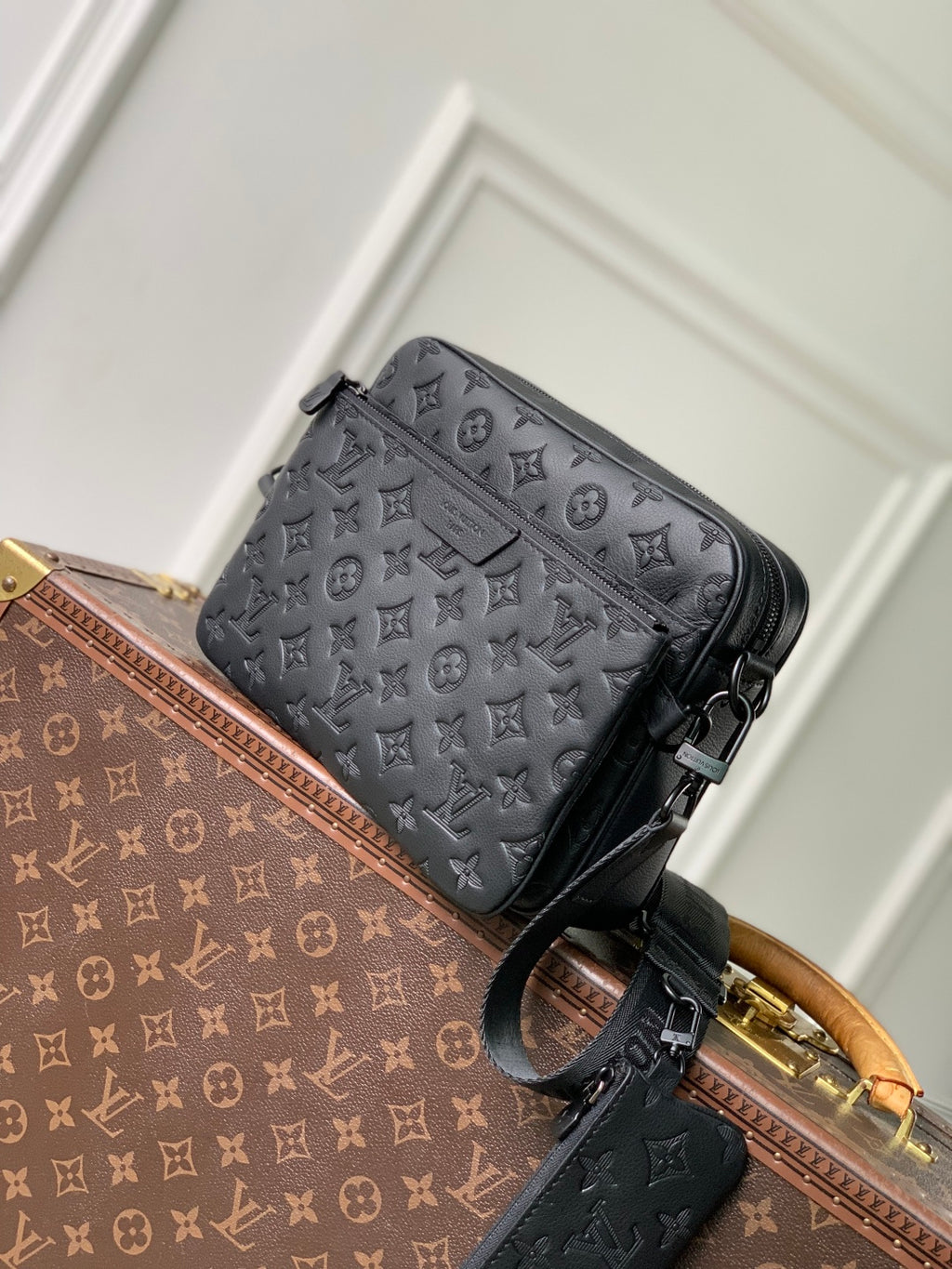 Louis Vuitton monogram crossbody bag with front pocket detail and top zip closure
