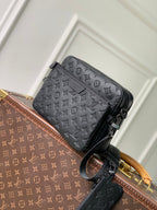 Louis Vuitton monogram crossbody bag with front pocket detail and top zip closure
