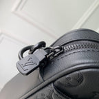 Louis Vuitton monogram bag close-up of zipper pull, ring, and black leather trim