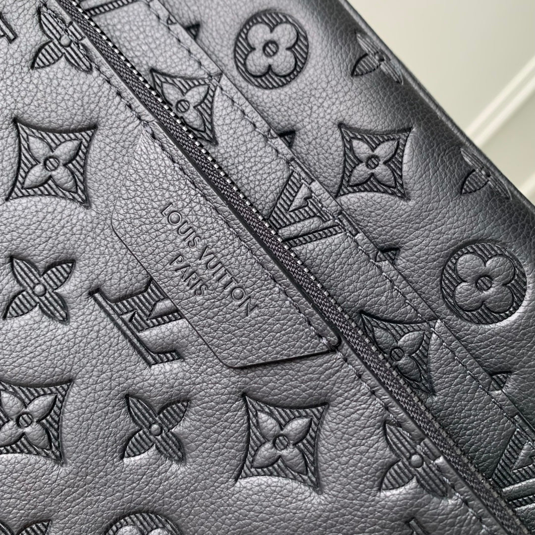 Louis Vuitton monogram leather bag close-up with debossed icons and stitched seams