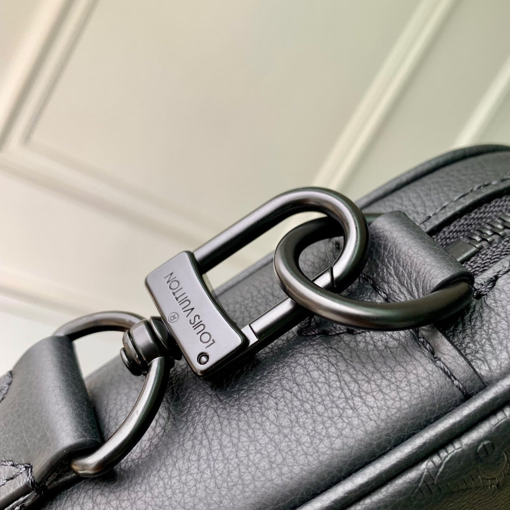 Louis Vuitton leather crossbody bag with metal carabiner ring and zipper hardware