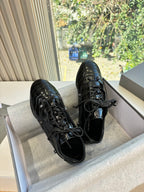 Black leather lace-up sneakers with blue sheen, side view