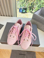 Women's pink lace-up sneakers pair with lace ties and side logo accents