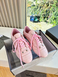 Women's pink lace-up sneakers with perforated sides and metal eyelets