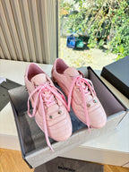 Women's pink lace-up sneakers with perforated sides and metal eyelets