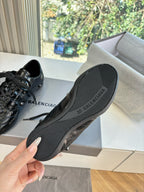 Black rubber outsole of leather lace-up sneakers, visible Balenciaga branding