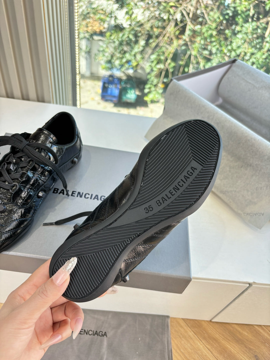 Black rubber outsole of leather lace-up sneakers, visible Balenciaga branding