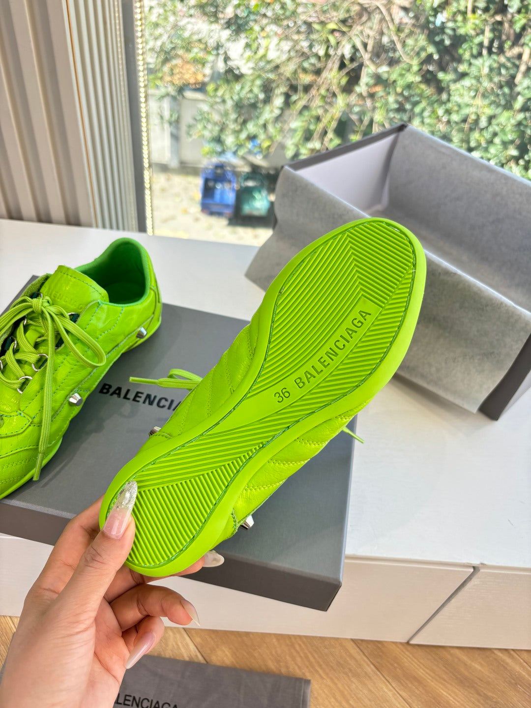 Balenciaga lime green sneaker sole detail with ribbed tread and embossed brand text