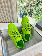 Balenciaga lime green lace-up sneakers, side view, with perforated toe and metal eyelets