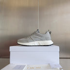 Dior unisex running-style sneakers in light gray mesh, lace-up front, sporty tread sole