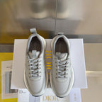 Pair of light gray lace-up sneakers with knit mesh texture, padded collar, and white sole