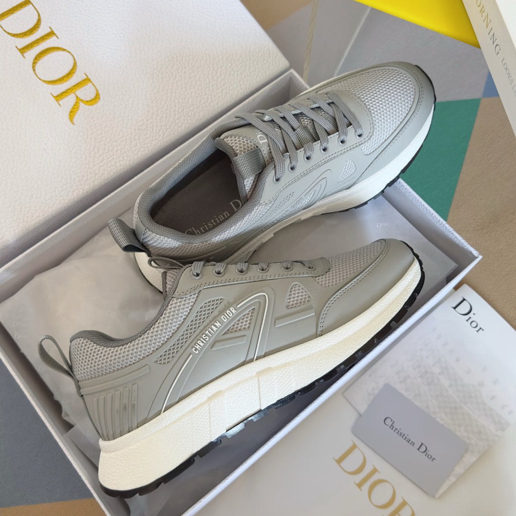 Dior unisex sneakers in light gray with lace-up design, textured panels, and thick rubber sole