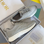 Dior unisex sneakers in light gray with lace-up design, textured panels, and thick rubber sole