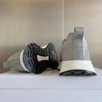Light gray lace-up sneaker showing treaded outsole, padded heel collar, and chunky midsole