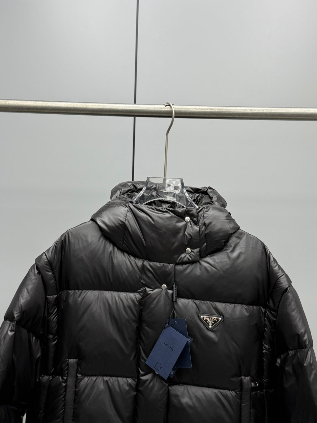 Prada black long puffer jacket, hooded front with Prada logo patch and button closure