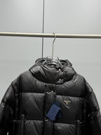 Prada black long puffer jacket, hooded front with Prada logo patch and button closure