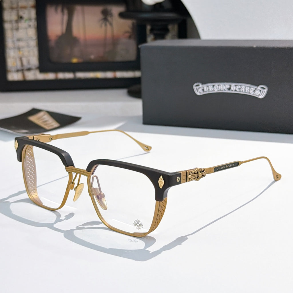 Gold and black eyeglasses with clear lenses, rectangular frame and metal temple details.