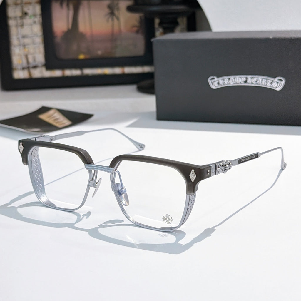 Silver and black eyeglasses with clear lenses, rectangular frame and patterned temples.