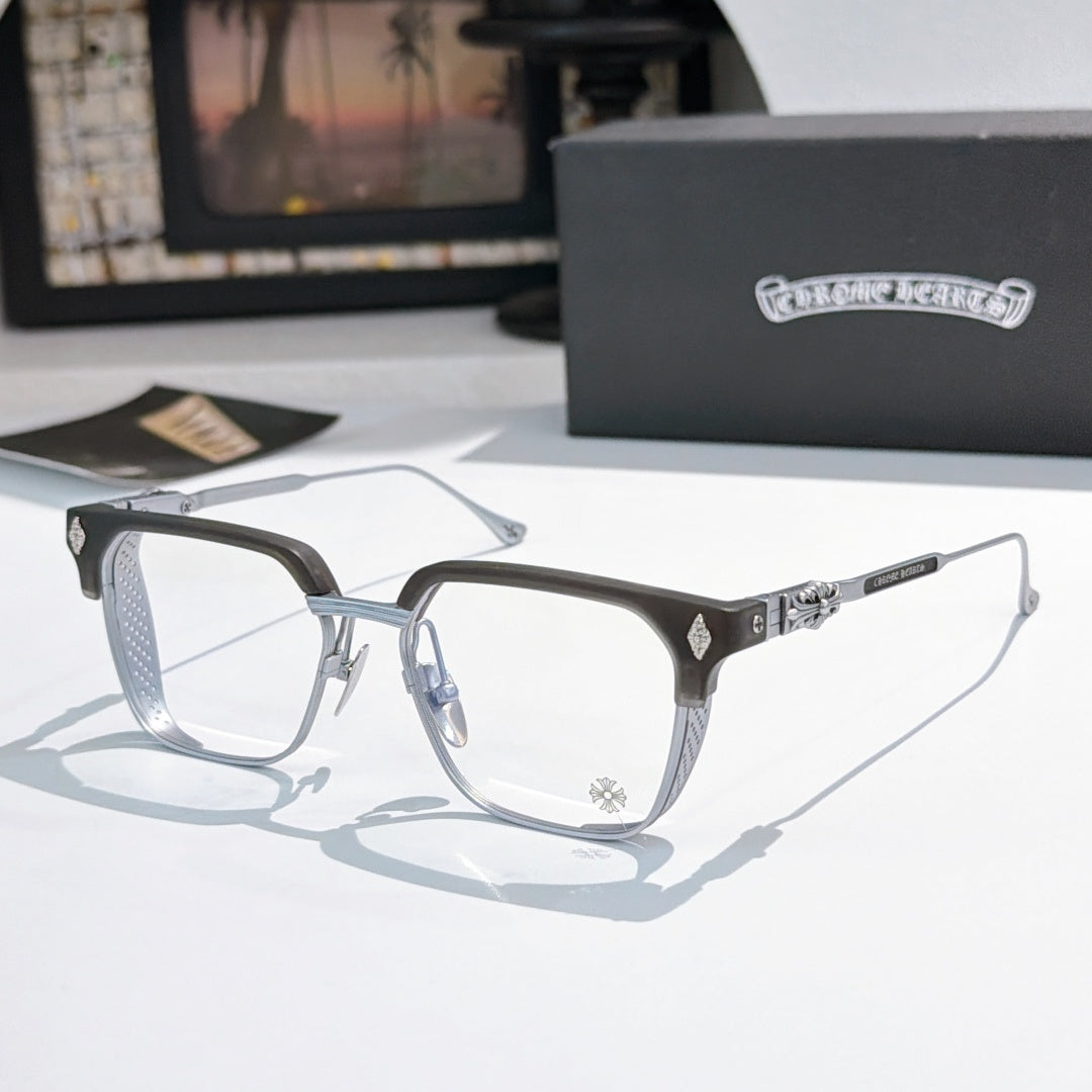 Silver and black eyeglasses with clear lenses, rectangular frame and patterned temples.