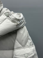 White hooded puffer jacket sleeve with snap buttons and quilted pocket flap
