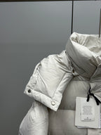 White puffer jacket shoulder and collar with button detail and attached tag