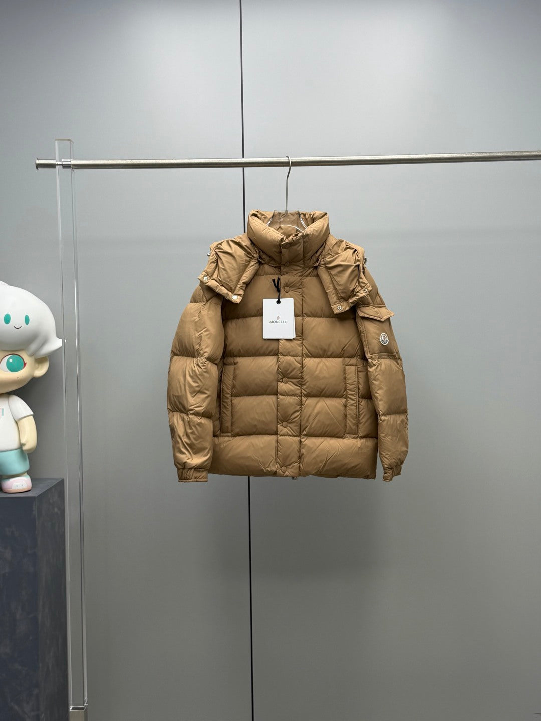 Moncler long puffer jacket in tan with hood, quilted panels, and snap buttons