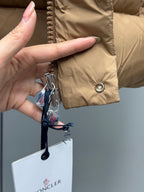 Moncler long puffer jacket tan with zipper pull and snap button closure